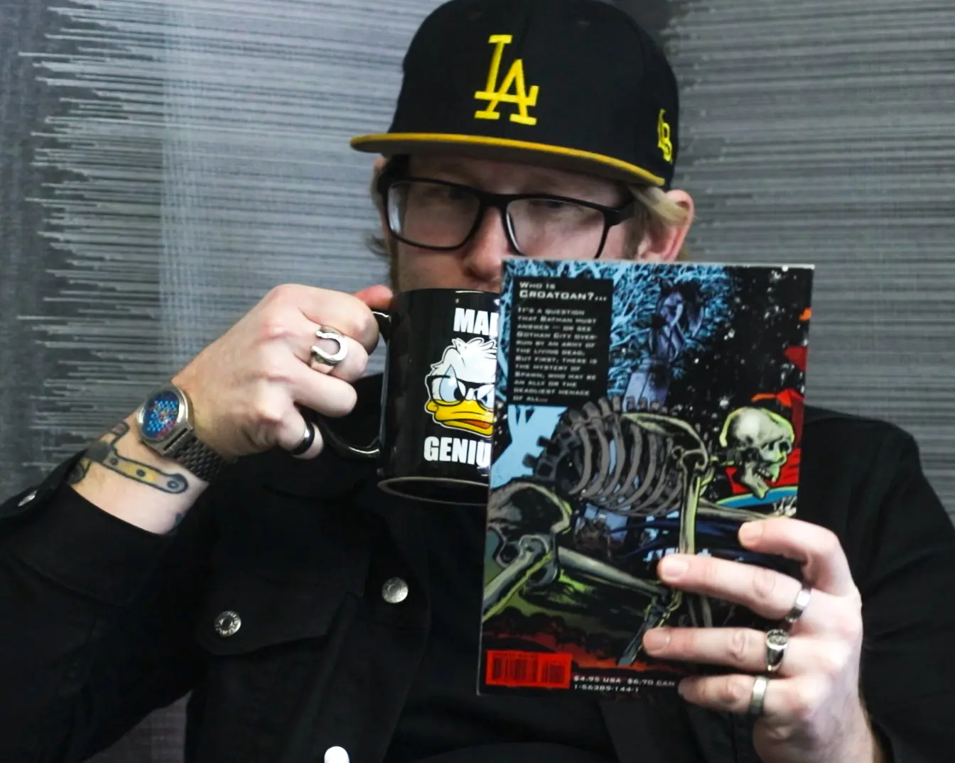 Jeff drinking a coffee and reading a comic!